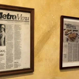 two framed newspapers on the wall