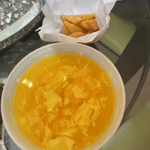 Egg drop soup. Comes with a wonton crisps on the side