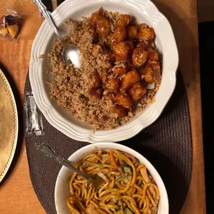 two bowls of noodles and a plate of meat