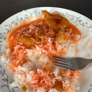 a plate of rice and meat with a fork