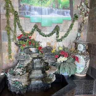 a fountain with flowers in it