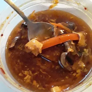 Hot and sour soup, has tofu carrots mushroom in it