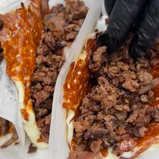 a person cutting into a taco
