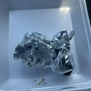 Aftermath of an asada burrito, no rice, extra cheese, onions, cilantro, guacamole