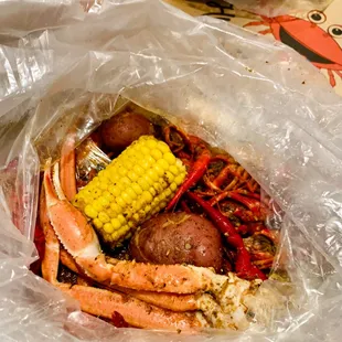 crab legs, corn, potatoes, and corn on the cob