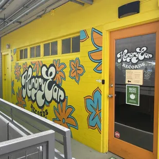 Outside wall art and entrance. You ring a doorbell to the left before you enter and they will let you in!