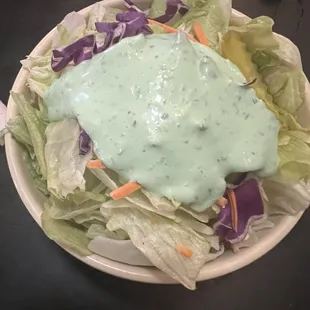 a plate of salad with dressing