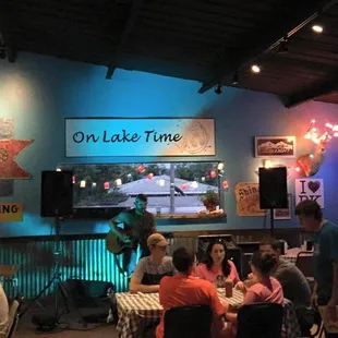 people sitting at tables in a restaurant