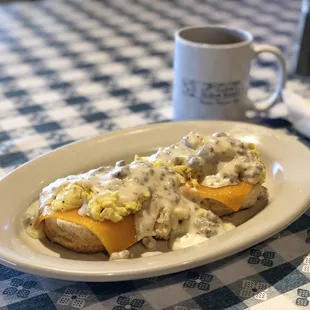 Texas Benedict!! Biscuit, cheddar, 2 eggs, covered in sausage gravy!!