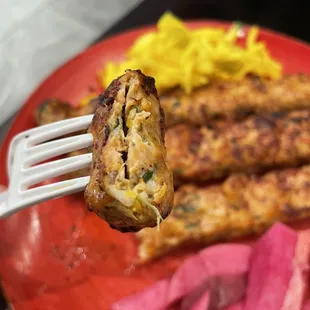 a fork holding a piece of meat