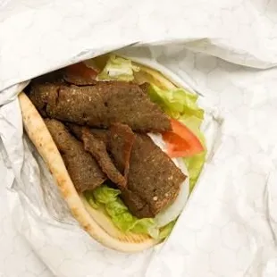 a pita filled with meat and lettuce