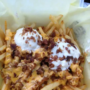 Deluxe fries with bacon, cheese, chili, and sour cream