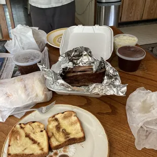 Harry's to go BBQ dinner: Ribs. Pulled pork, baked beans, potato salad,garlic bread, tub of sweet sauce, and buns for pork sammiches