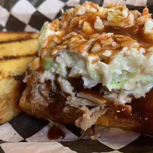 Pulled Chopped Pork Sandwich topped with coleslaw.