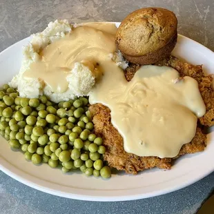 Pony chicken-fried steak with mashed potatoes, peas, and a bran muffin