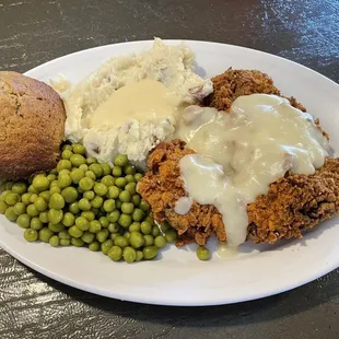 Chicken-fried steak (&quot;pony&quot; size) with mashed potatoes, peas, and a bran muffin