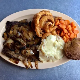 Exceptional liver and onions with onion rings, carrots, mashed potatoes, and a bran muffin