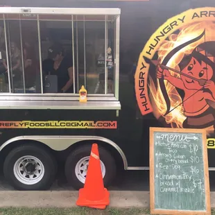 a food truck parked in front of a restaurant