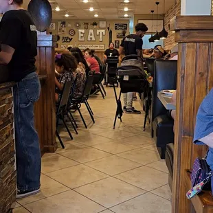 a woman sitting on a bench in a restaurant