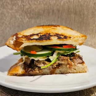 Kalua-yaki: Braised kalua pork, pickled ginger, cucumber, daikon sprouts, homemade yaki sauce, mozzarella, jalapeno, furikake