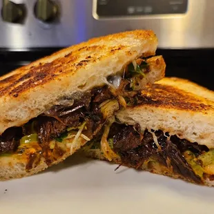 Test phase: korean braised beef, cucumber kim chee, jalapeno, cheddar, spicy gochujang mayo, white onion