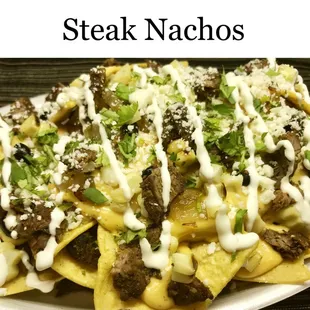 a plate of steak nachos