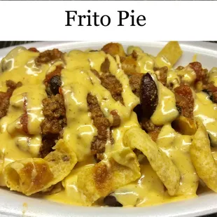 a plate of pasta with cheese and meat