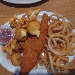 Fish, shrimp and clams with onion straws