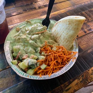 Hummus bowl with chicken, w/carrots, cucumber &amp; tomato topping and creamy jalapeño feta sauce on top.