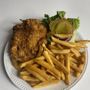 a plate of food with french fries and a pickle