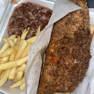 Whole fried cash dish with fries and red beans and rice