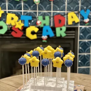 Mario Star cake pops with funfetti, and blue round cake pops with vanilla filling.