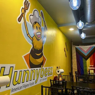 a yellow wall with a bee on it