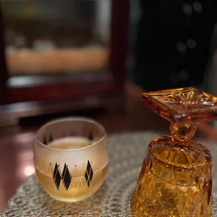 a glass and a bowl on a table