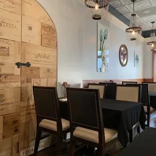 a dining room with wine crates on the wall