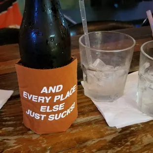 a bottle of beer and a glass of ice