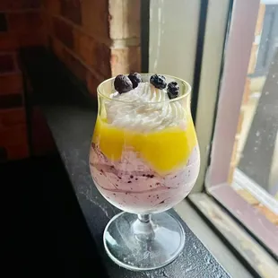 a dessert in a glass on a window sill