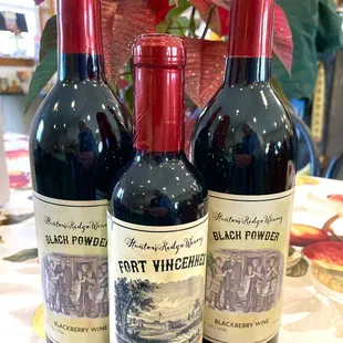 three bottles of wine on a table