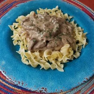 Beef tips over noodles
