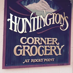 a sign for huntington&apos;s corner grocery