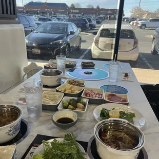 Table with our chosen broths, sauces, and ingredients grabbed from the bar