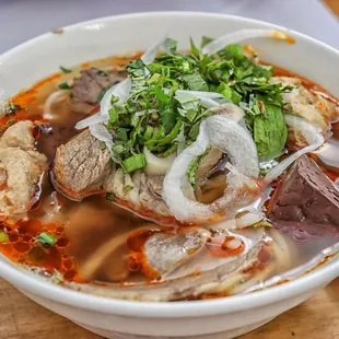 a bowl of soup with meat and vegetables