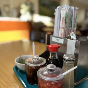 a table with condiments and condiments