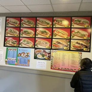 a woman standing in front of a menu