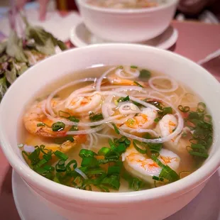 a bowl of soup with shrimp and noodles