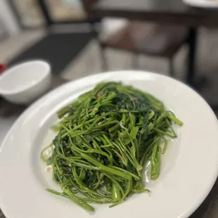 a plate of green vegetables on a table