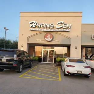 two cars parked in front of a restaurant