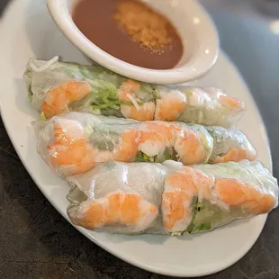 a plate of food with dipping sauce
