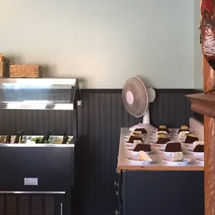 Dirty fan blowing over food. Oscillating fan blowing over uncovered cake and salad bar.