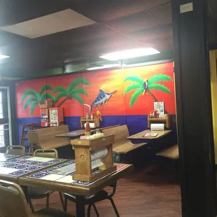 a dining area with tables and chairs